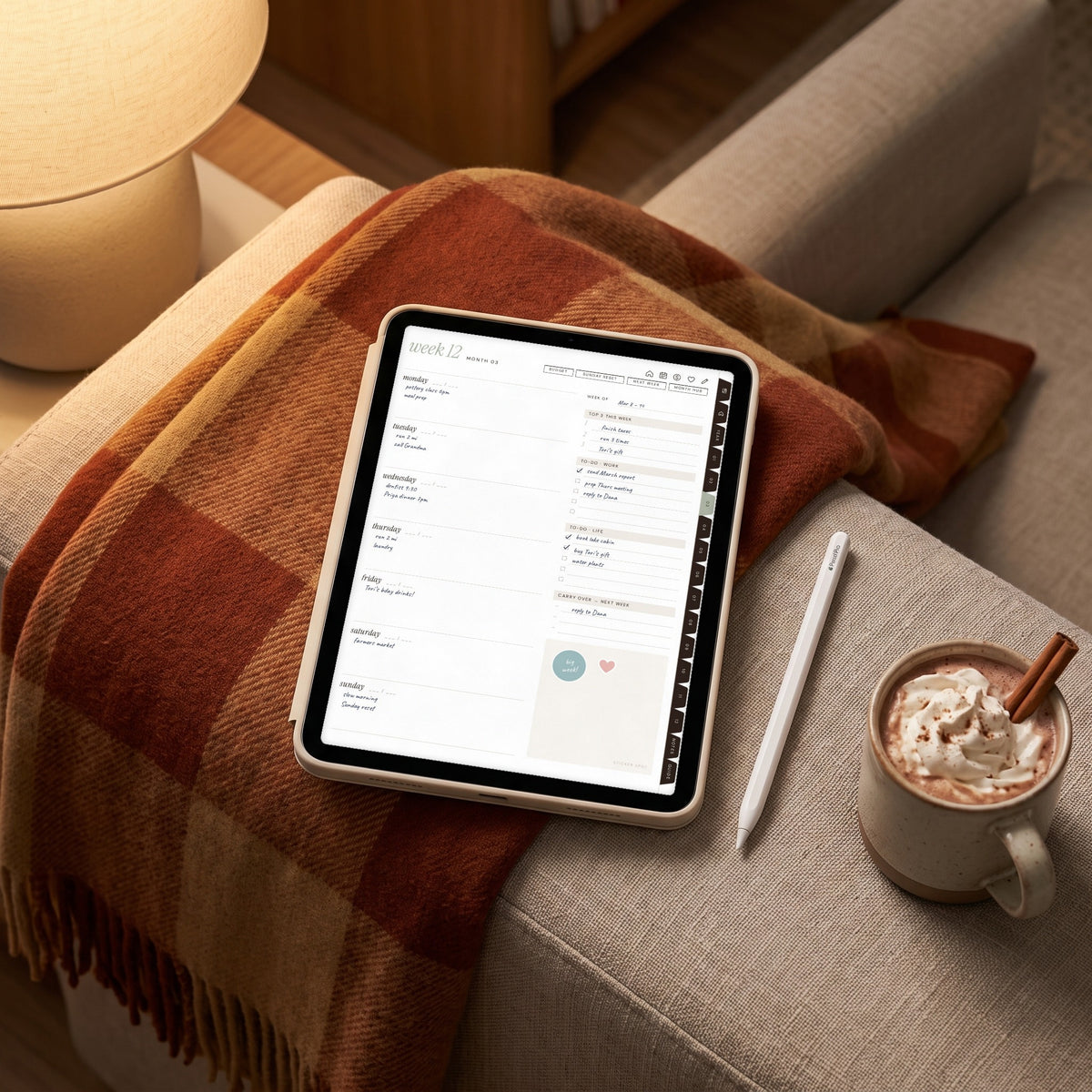 Undated weekly spread on an iPad in a cream case on a sofa with a plaid blanket