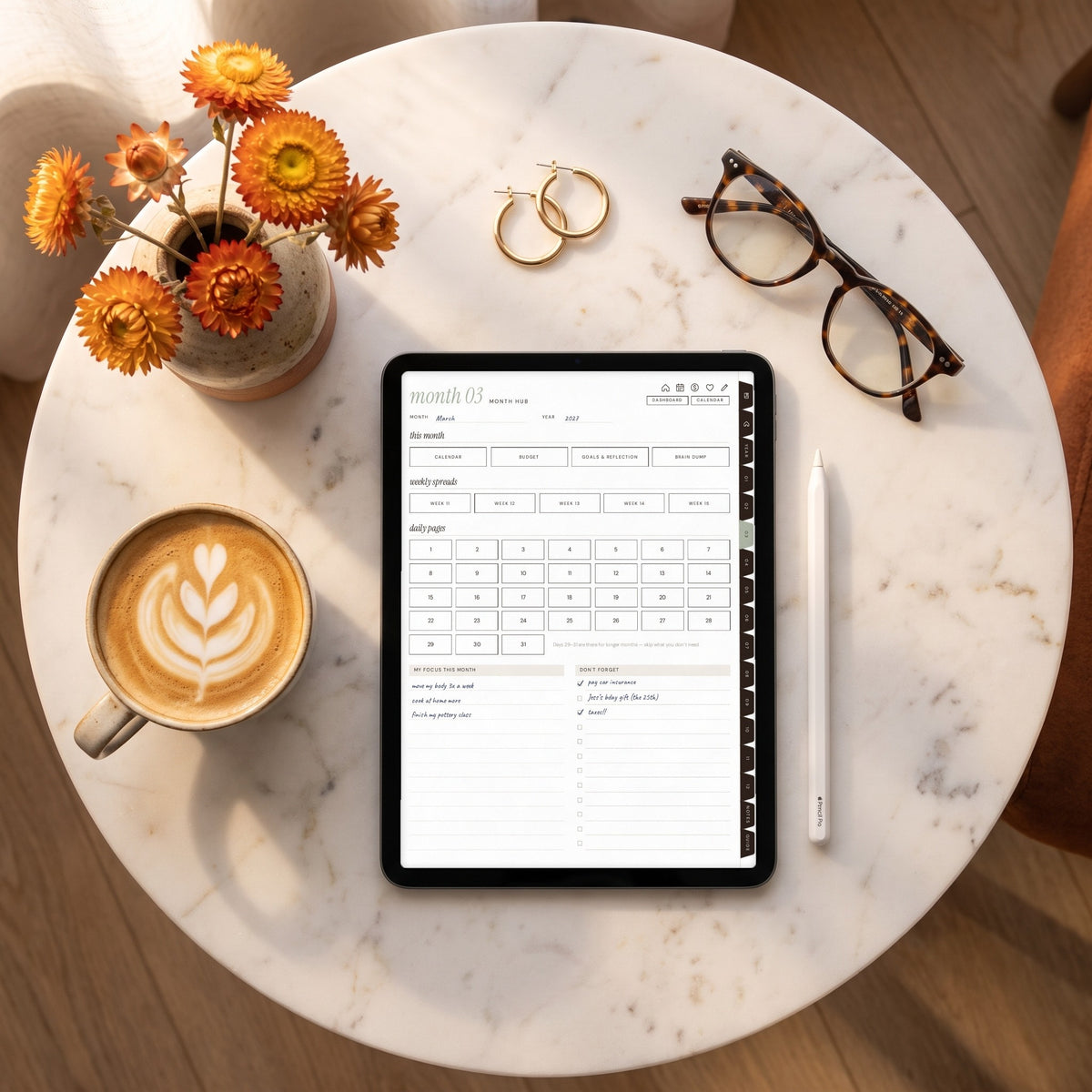 Undated month hub page on an iPad on a marble table with a cappuccino