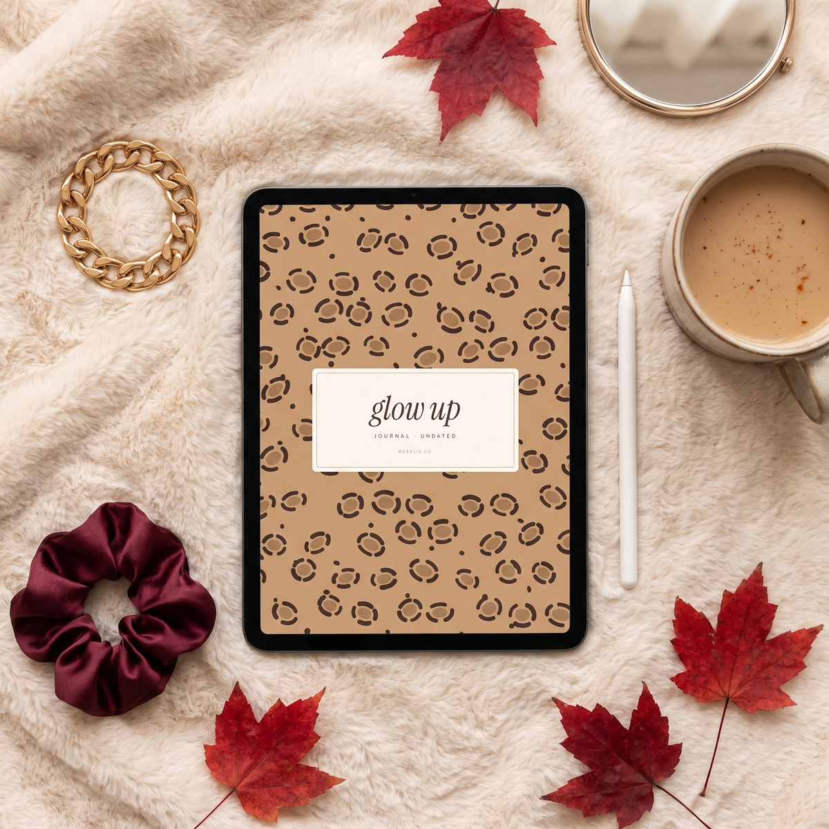 Glow Up journal leopard cover on an iPad with gold jewelry and chai